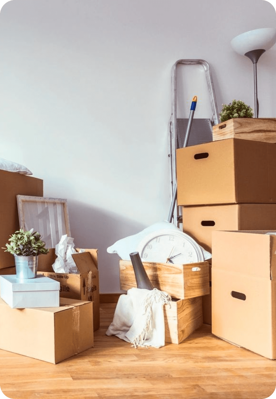 Packed moving boxes and home items ready for relocation.