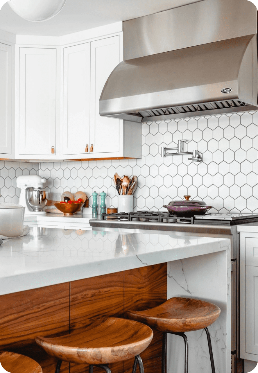 Modern kitchen with white hexagonal tile backsplash and wooden cabinetry.